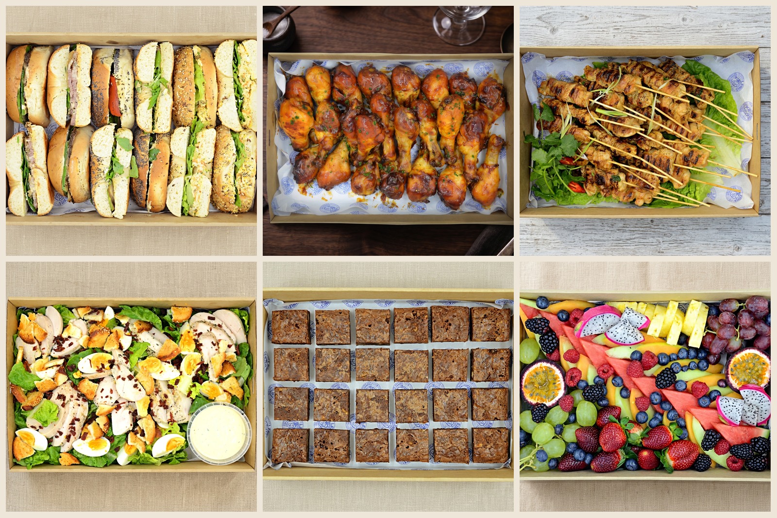 Office catering grazing spread with sandwiches, chicken drumsticks, skewers, Caesar salad, brownies and fruit platter